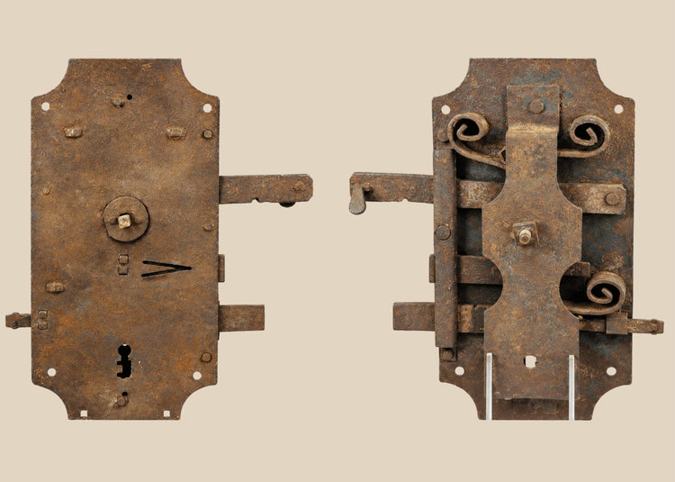 18th-century European hand-forged iron door lock with rectangular form, exposed keyhole, scroll springs, and aged patina.