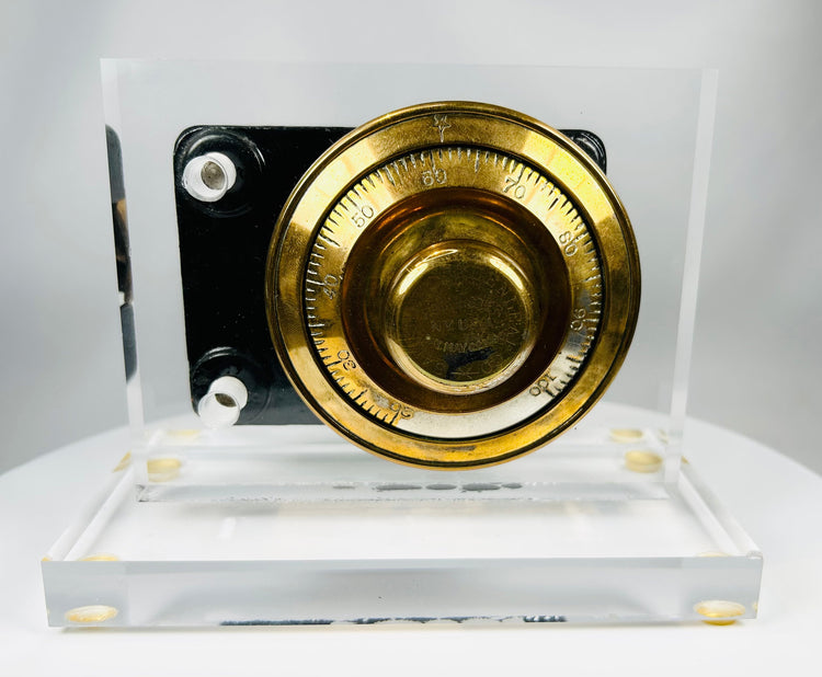 Early 20th century safe lock mechanism showing engraved brass combination dial