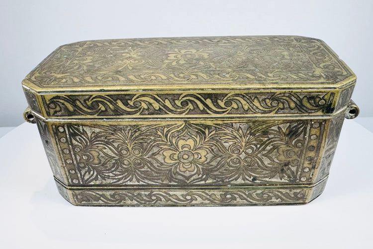 Late 18th to early 19th-century Philippine betel nut box with intricate brass floral inlay and aged mixed-metal surface.