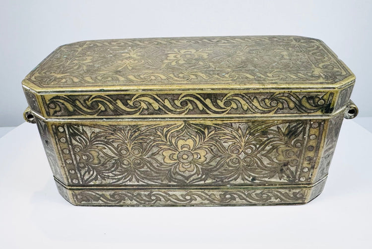 Late 18th to early 19th-century Philippine betel nut box with intricate brass floral inlay and aged mixed-metal surface.