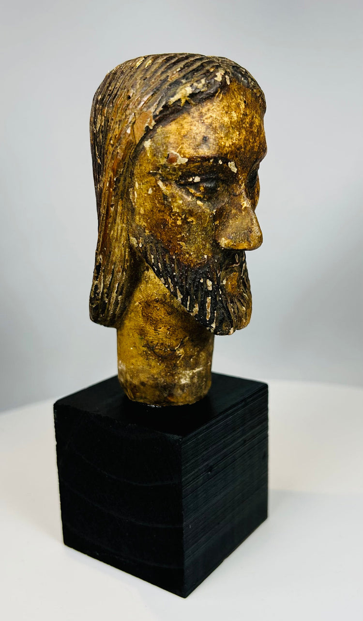 European devotional sculpture of Christ with aged paint remnants