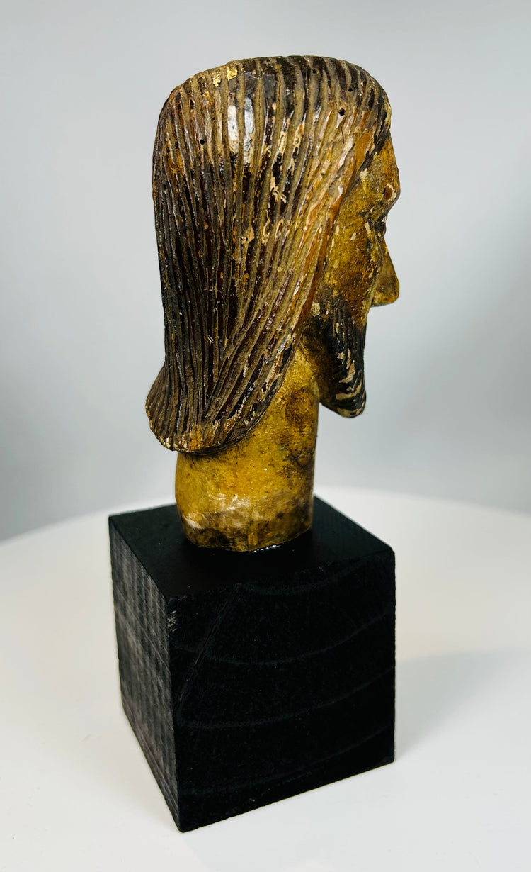 Religious wood sculpture of Christ with long hair and beard