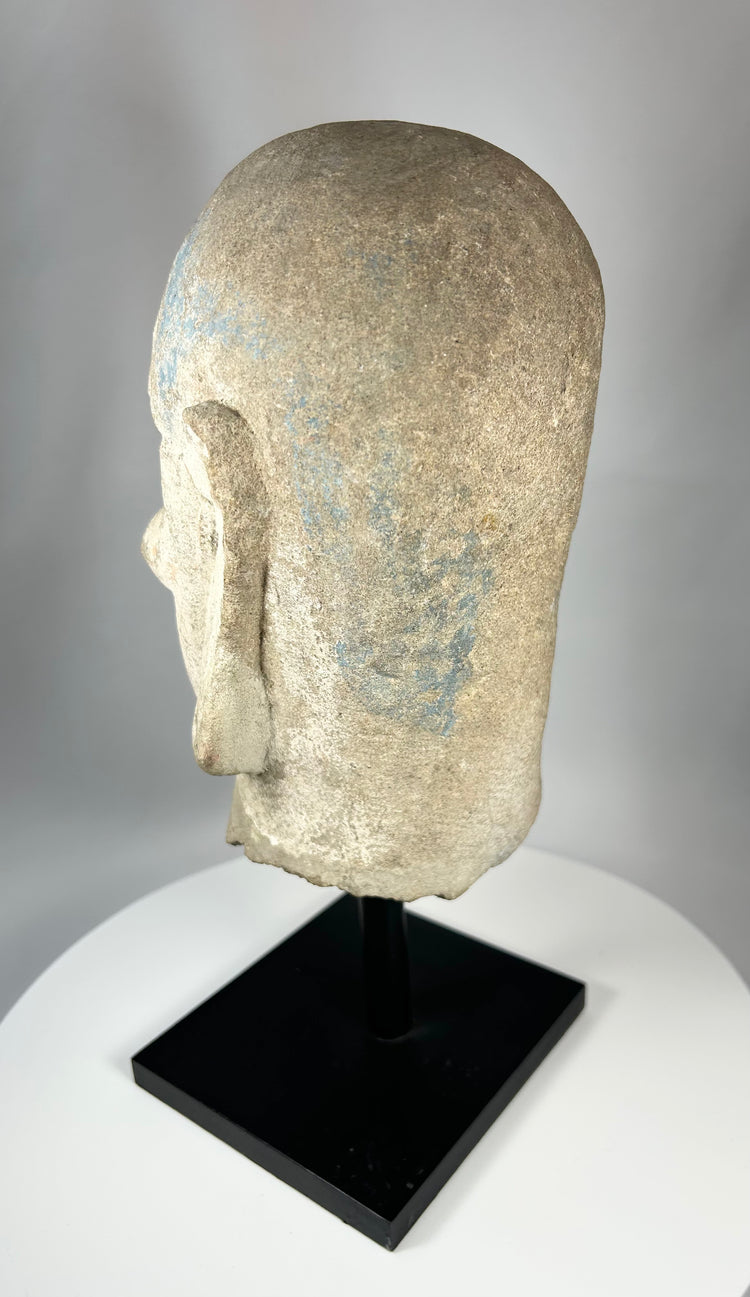 Chinese Qing Dynasty Luohan stone head with expressive features and elongated ears.