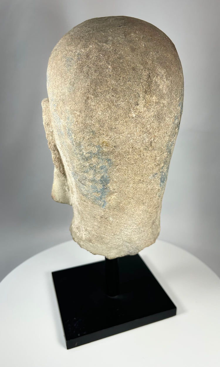 Antique Chinese Buddhist stone sculpture of a Luohan mounted on a later metal display stand.