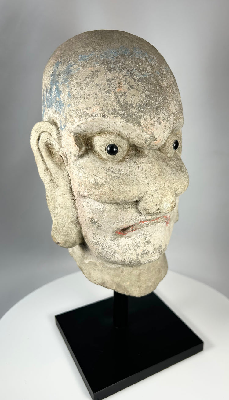 Antique Chinese stone head of a Luohan disciple from the Qing Dynasty, circa 18th–19th century.