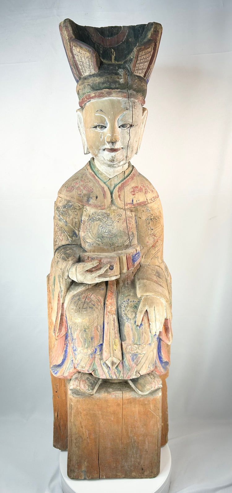 Antique Chinese temple figure of a seated magistrate with painted robes and ceremonial tablet.