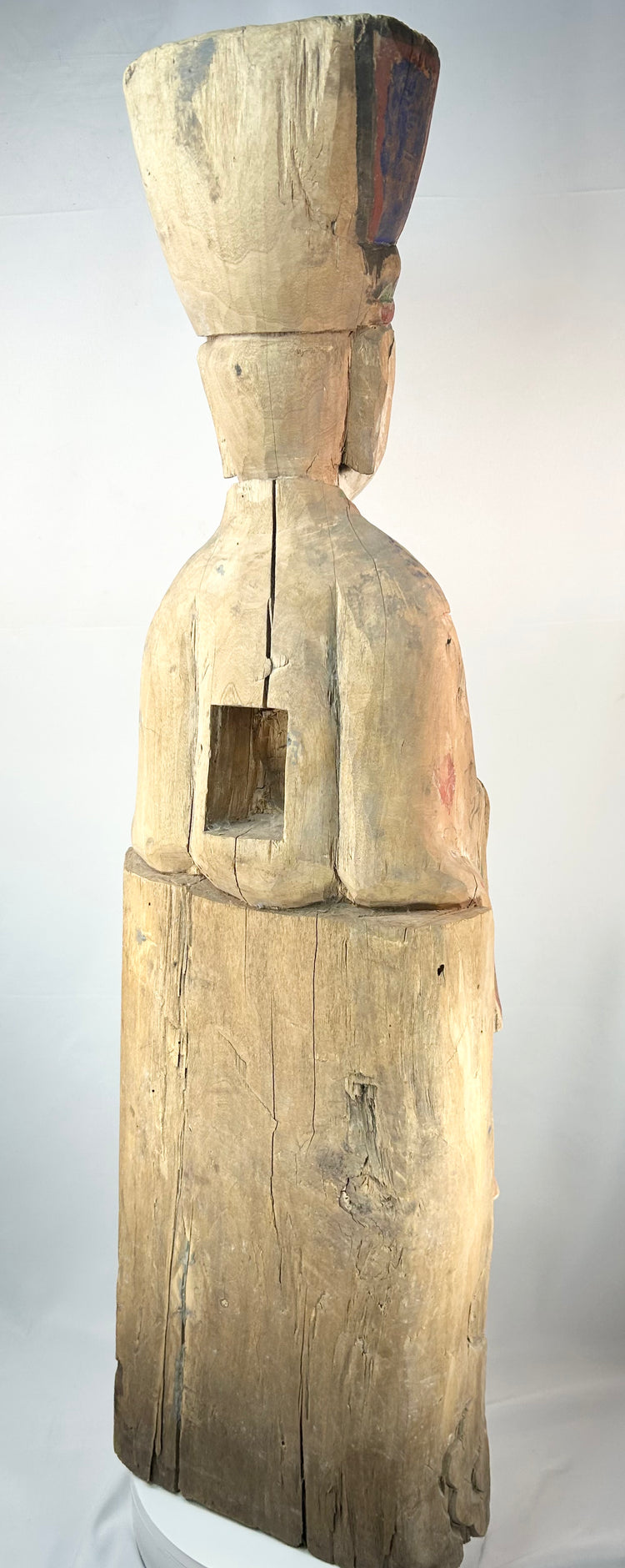 Chinese carved wood devotional sculpture of a seated official with painted dragon motifs.