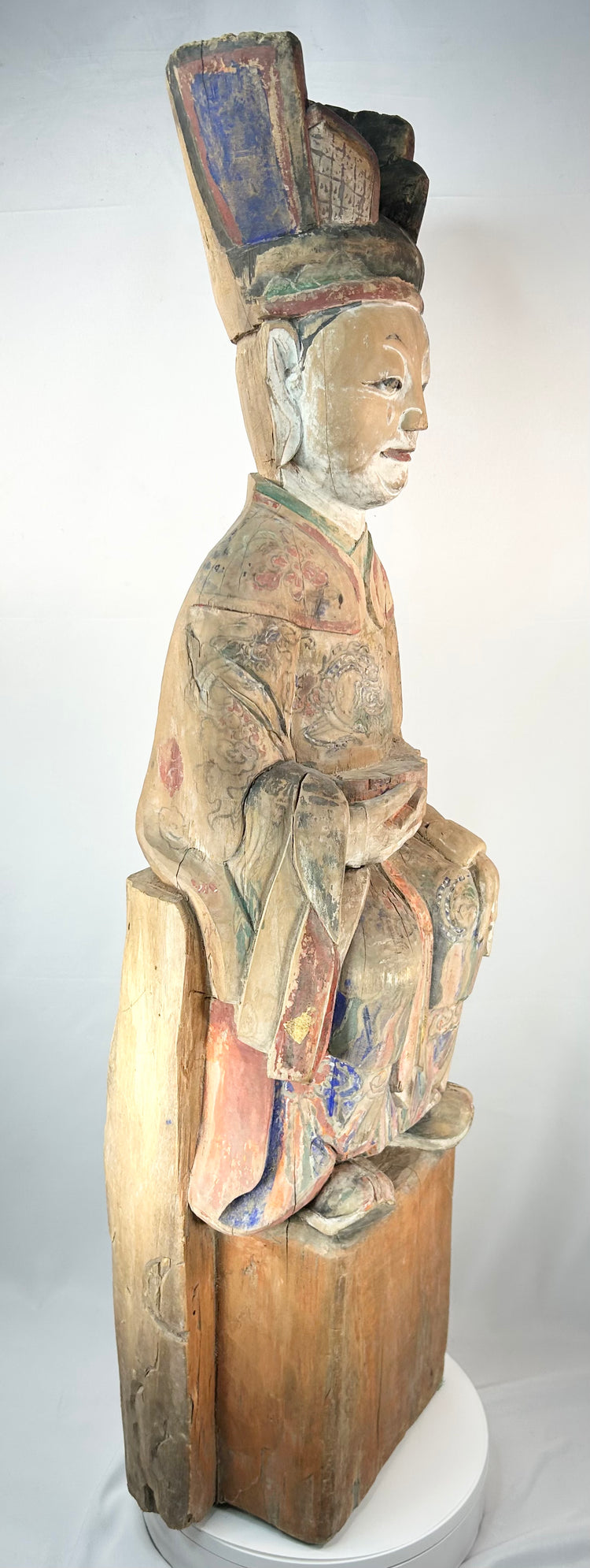 Antique Chinese carved wooden official figure with elaborate painted robes and tablet.