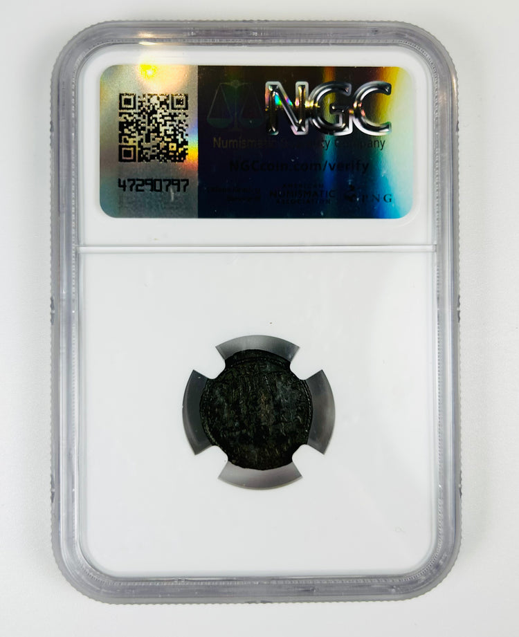 Historic Roman bronze coin issued under Emperor Constans (4th century CE), small AE4 nummus encapsulated for preservation.
