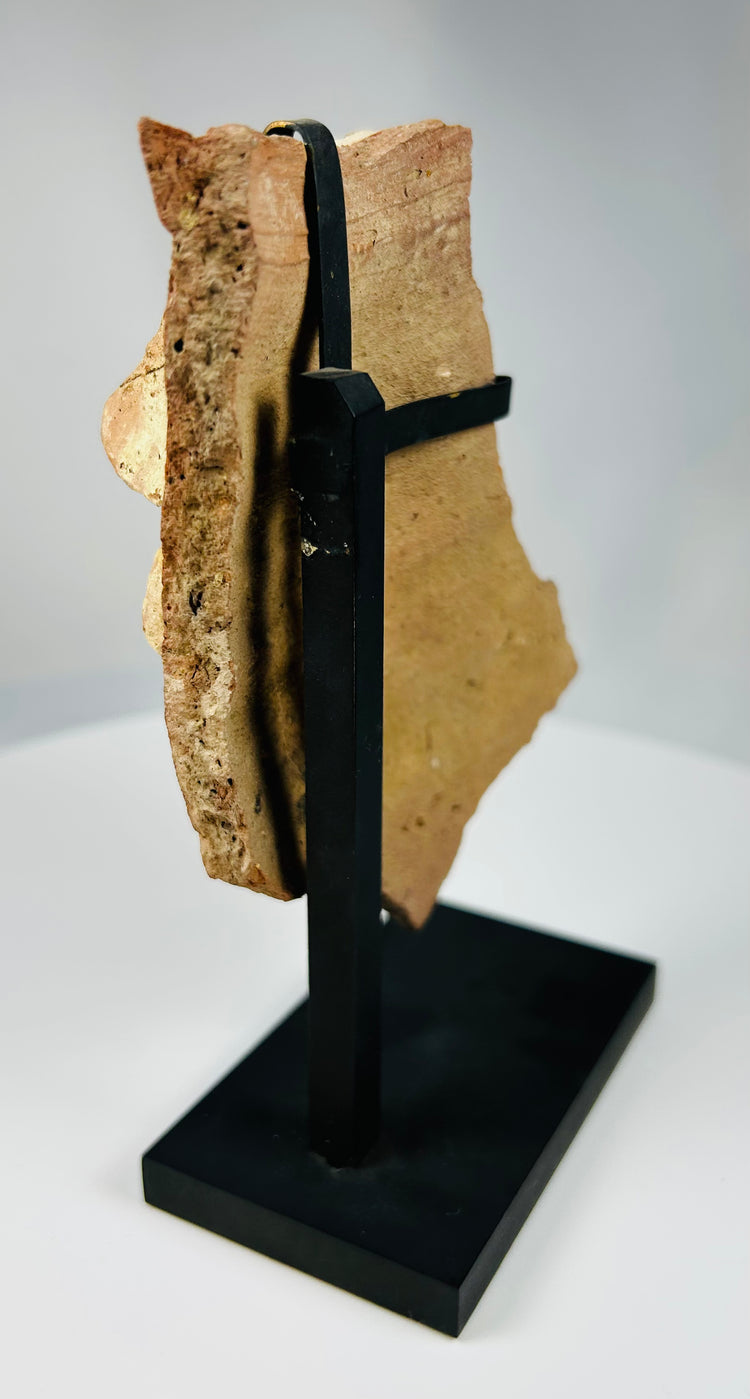 Hellenistic-Roman terracotta theatrical mask fragment showing detailed eye socket and open mouth expression.