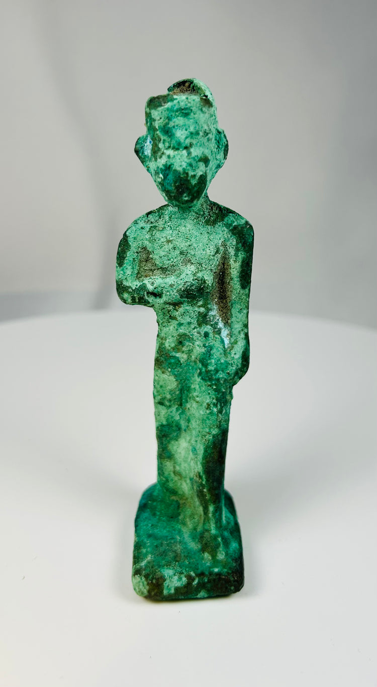 Small ancient Egyptian bronze votive figure of a female goddess mounted on base with green patina.