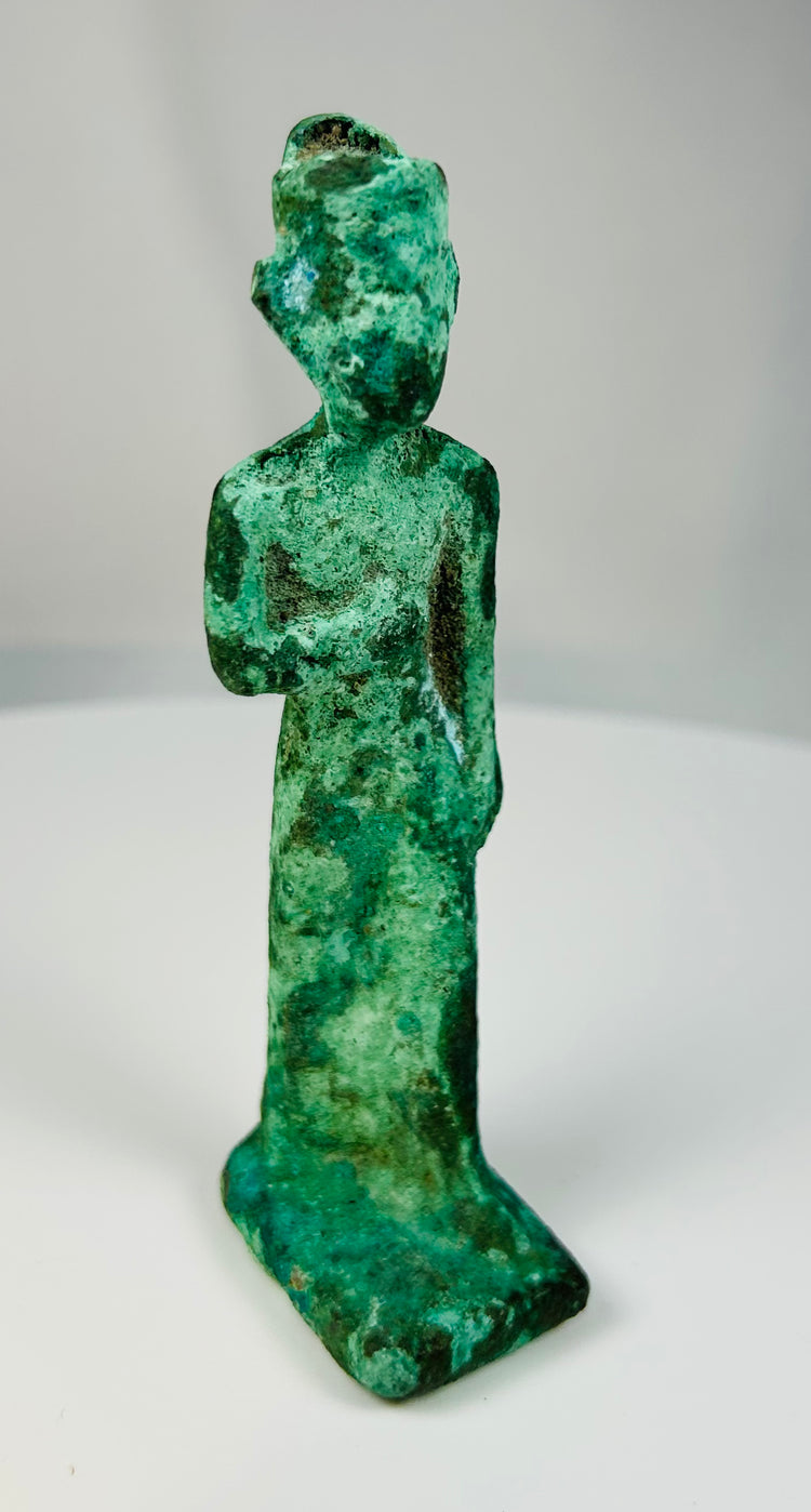 Archaeological bronze votive figurine from ancient Egypt with natural patina and temple dedication form.