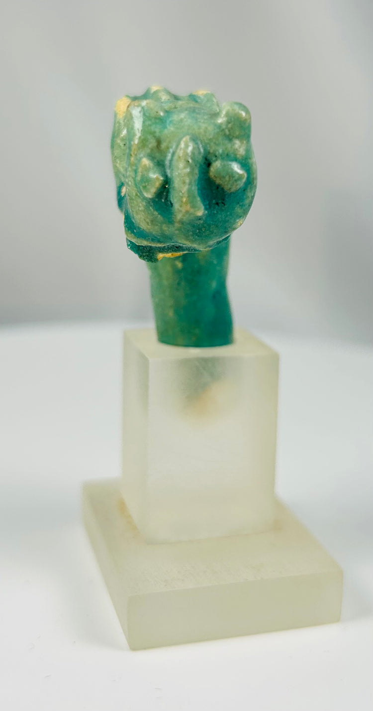 Ancient Egyptian faience ritual vessel handle fragment with Bastet feline motif.