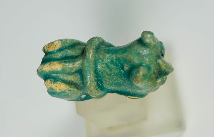 Ancient Egyptian Bastet-themed faience handle fragment with turquoise glaze.