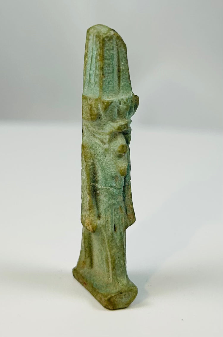 Ancient Egyptian Nefertem amulet in glazed faience with lotus headdress.