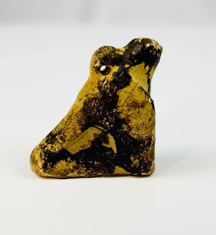 Ancient Egyptian Horus falcon amulet worn as a protective charm in antiquity.