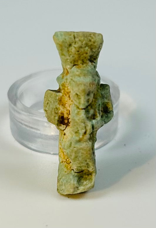 Small Egyptian green faience Bes amulet worn as a protective charm in antiquity.