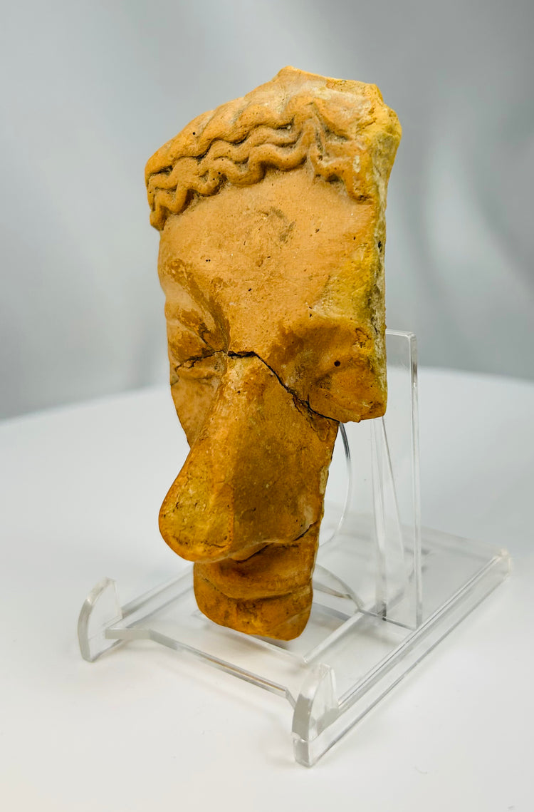 Greco-Roman theatrical mask fragment in terracotta representing classical stage tradition