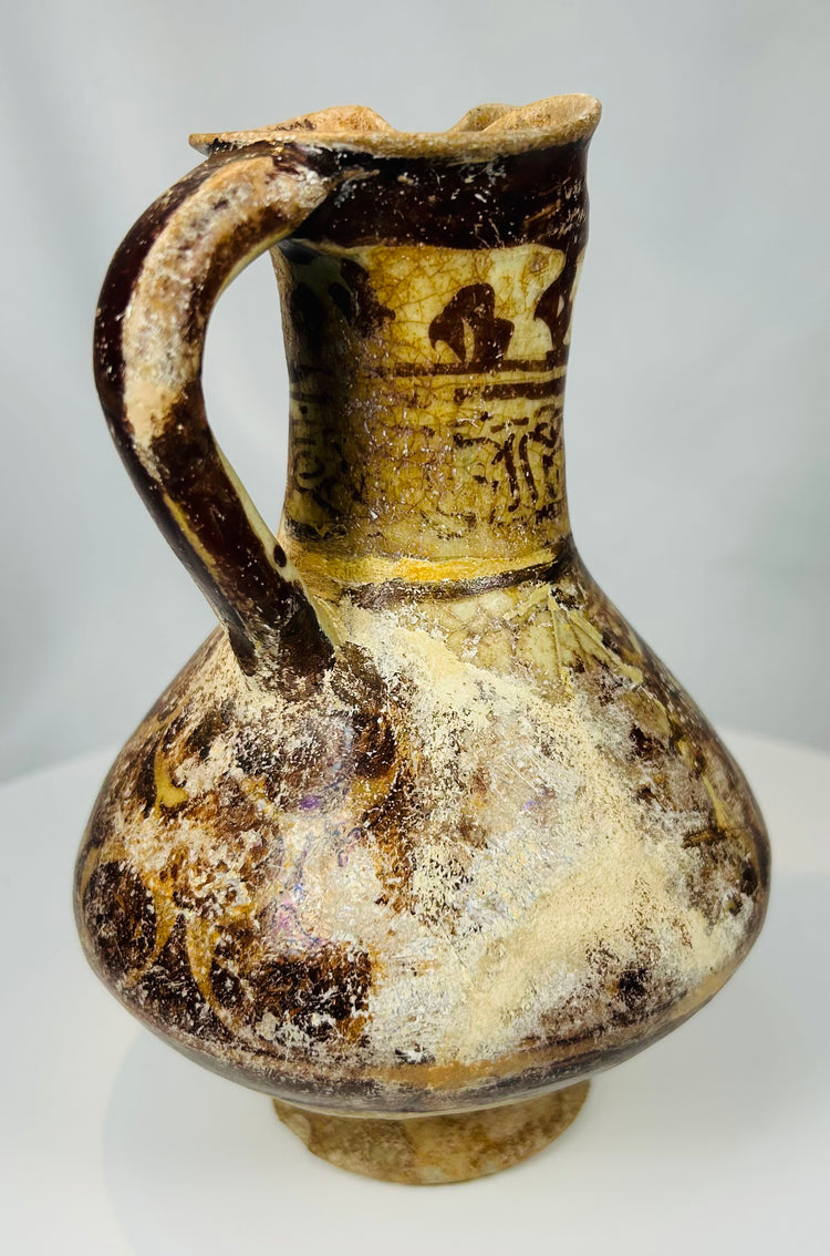 Kashan pottery ewer from the Islamic Golden Age with honey colored glaze