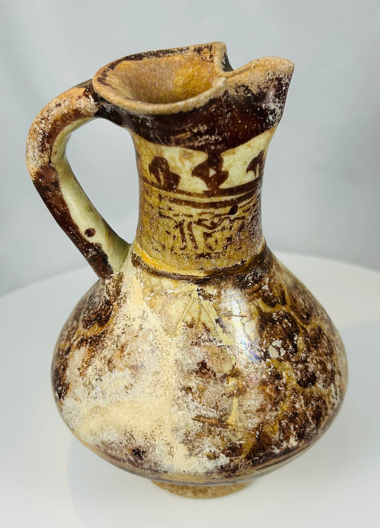 Seljuk period Persian glazed earthenware ewer with manganese painted motifs