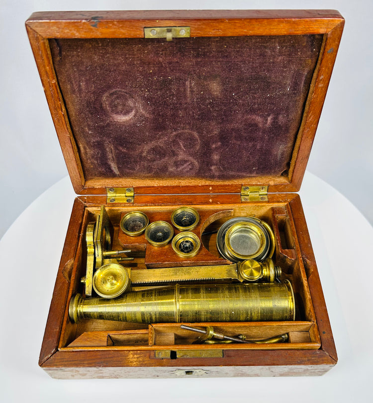antique Gould type microscope with brass body and wooden storage box