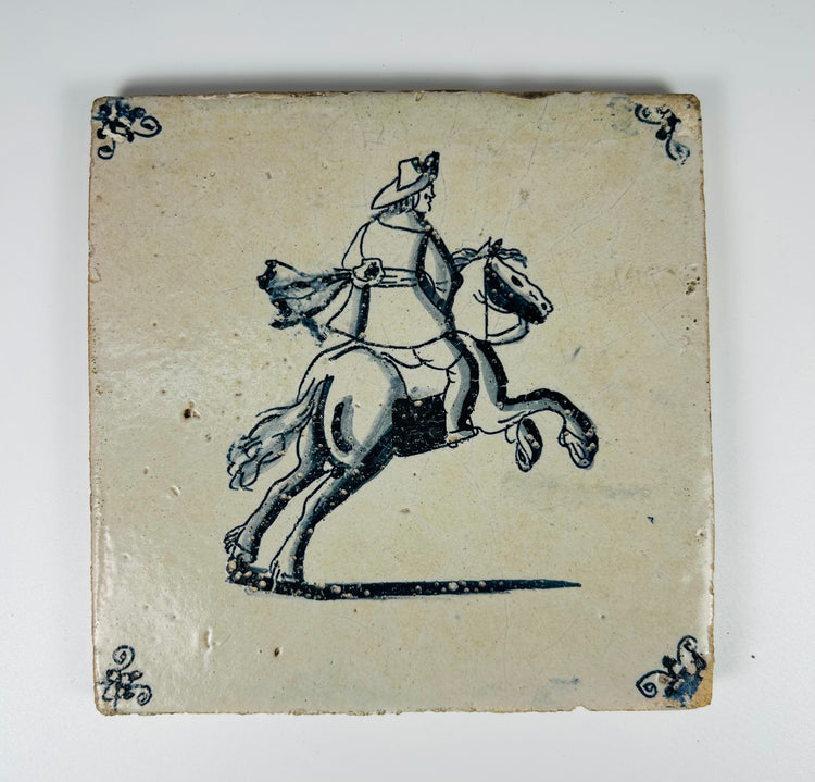 antique Delftware tile depicting rider on galloping horse