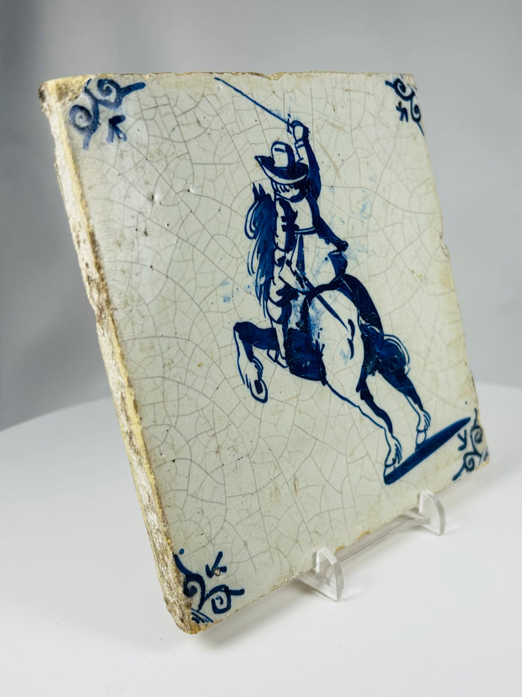 antique Netherlands Delft tile with cobalt blue swordsman scene