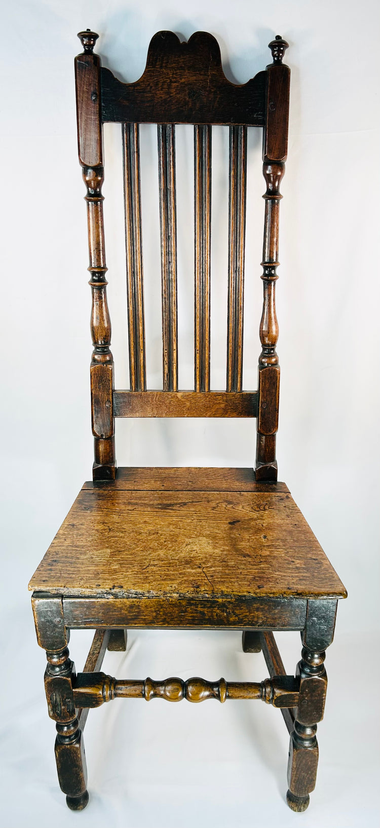 Antique Cromwellian style oak chair with turned legs and plank seat circa 1680–1720
