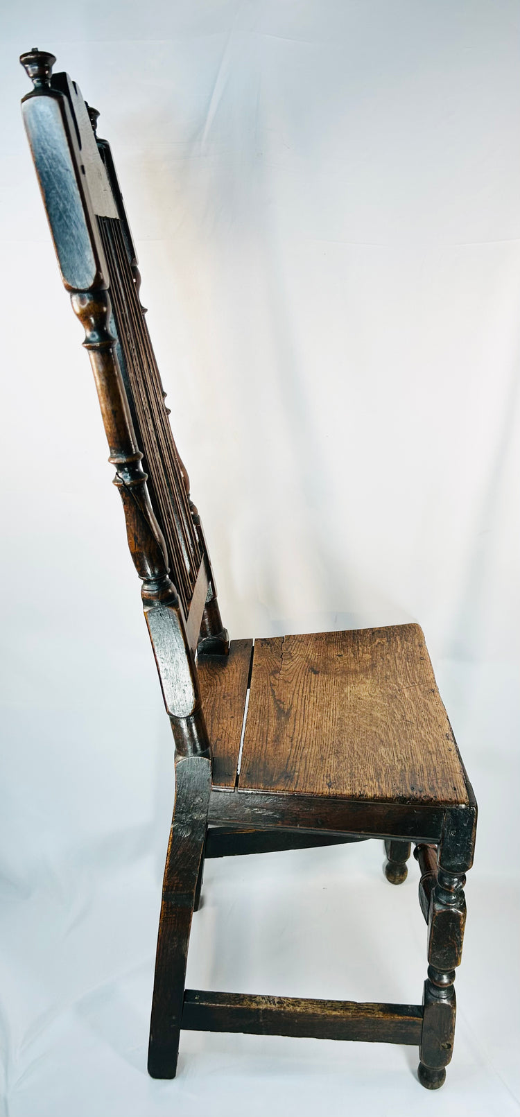 Antique English oak chair with two plank seat and turned front stretcher detail