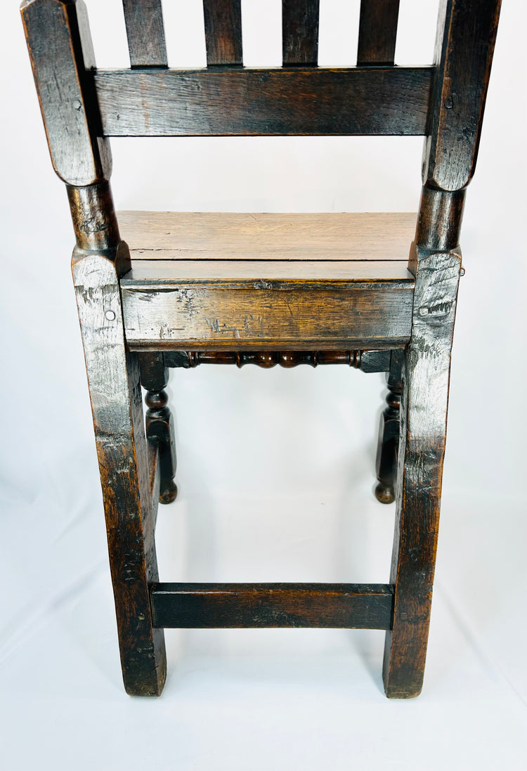 High back English oak chair with narrow vertical slats and aged patina