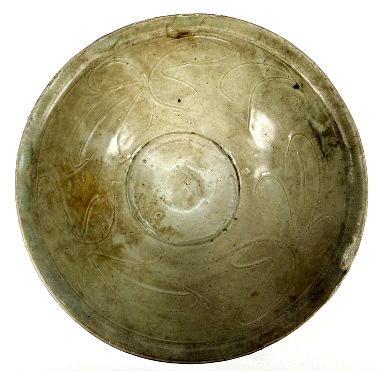 Ancient Chinese Song Dynasty celadon bowl associated with the National Museum of the Philippines collection, featuring traditional floral ornamentation and documented shipwreck provenance.