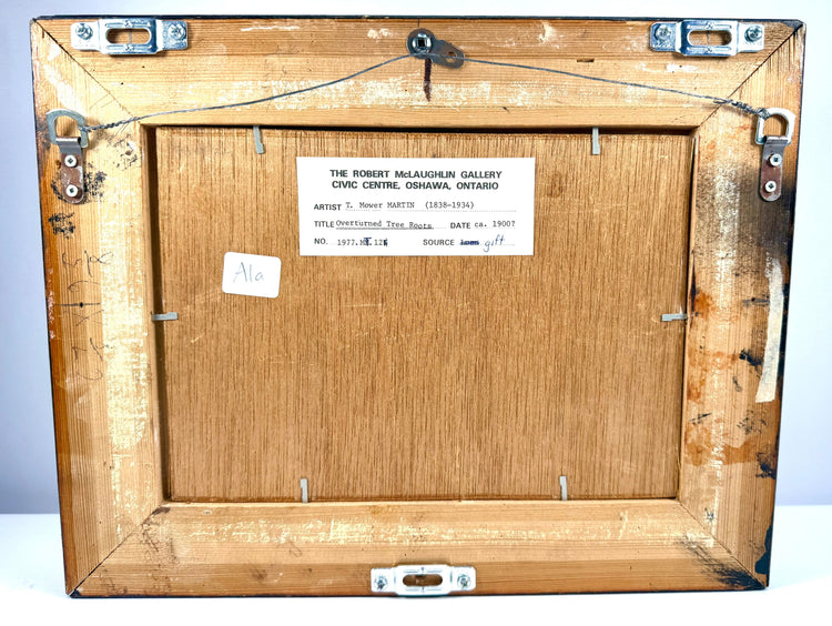 Original collection label from the Robert McLaughlin Gallery in Oshawa, Ontario, identifying the painting as Overturned Tree Roots by Thomas Mower Martin, circa 1900.
