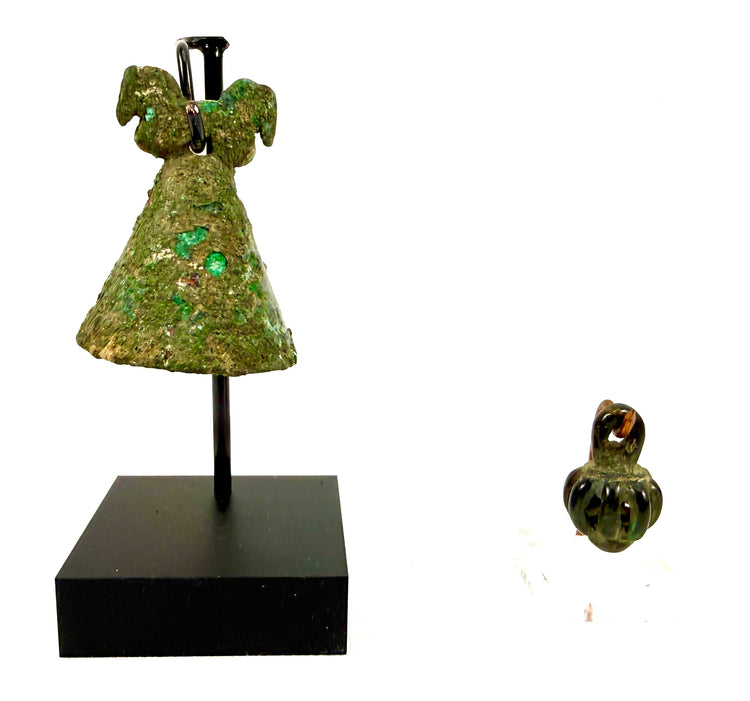 Pair of ancient Iranian cast bronze pendant bells featuring an Iron Age Luristan openwork rattle and a Parthian horse-head bell, mounted together for display.