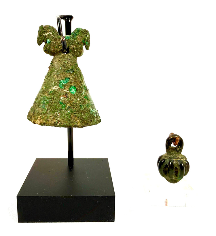 Ancient Persian bronze bell collection spanning the Iron Age to Parthian Period, featuring two distinct suspended bells with archaeological patina and decorative metalwork.