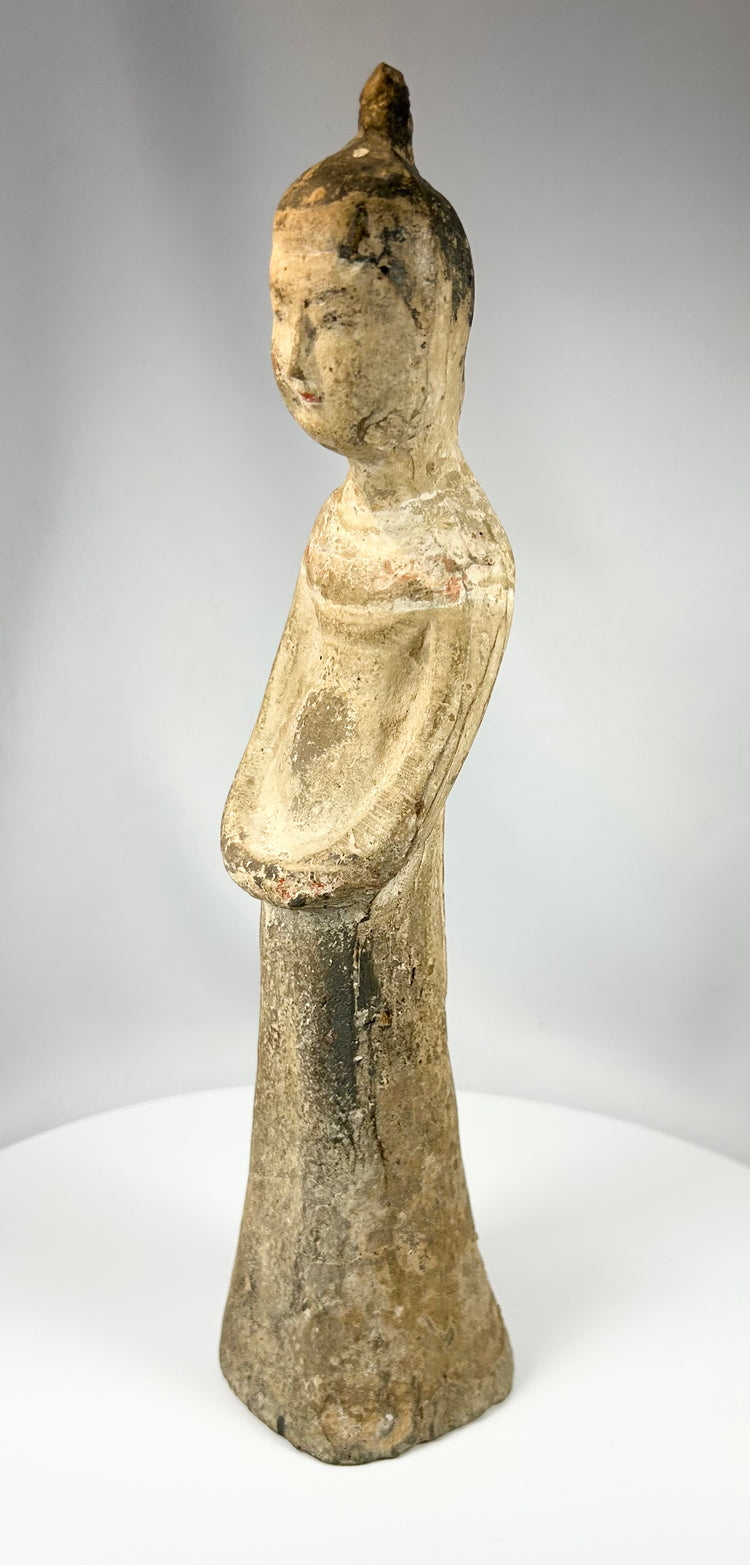 Chinese pottery figure with elongated proportions and traditional folded pose