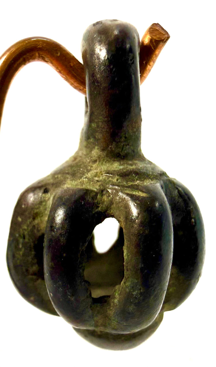 Ancient Iranian Luristan bronze rattle featuring an openwork cage-like structure, suspension loop, and traditional cast metalwork dating to circa 1000–700 BCE.