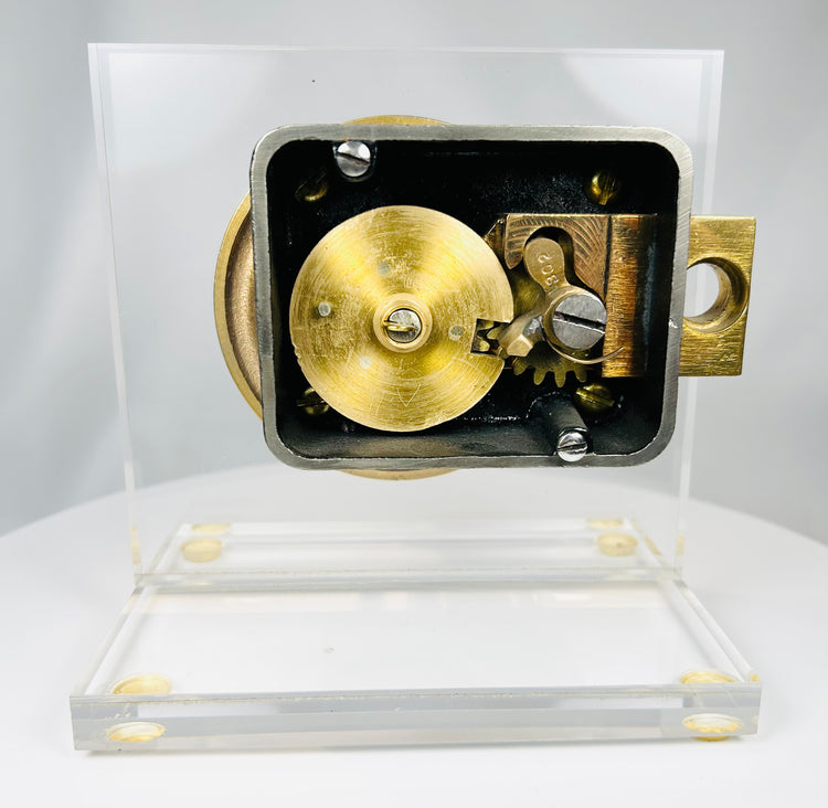 Herring Hall Marvin safe lock with transparent backing revealing gear mechanism