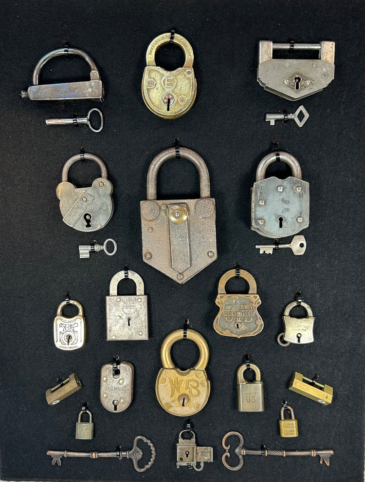 Antique locks and skeleton keys arranged in decorative shadow box frame