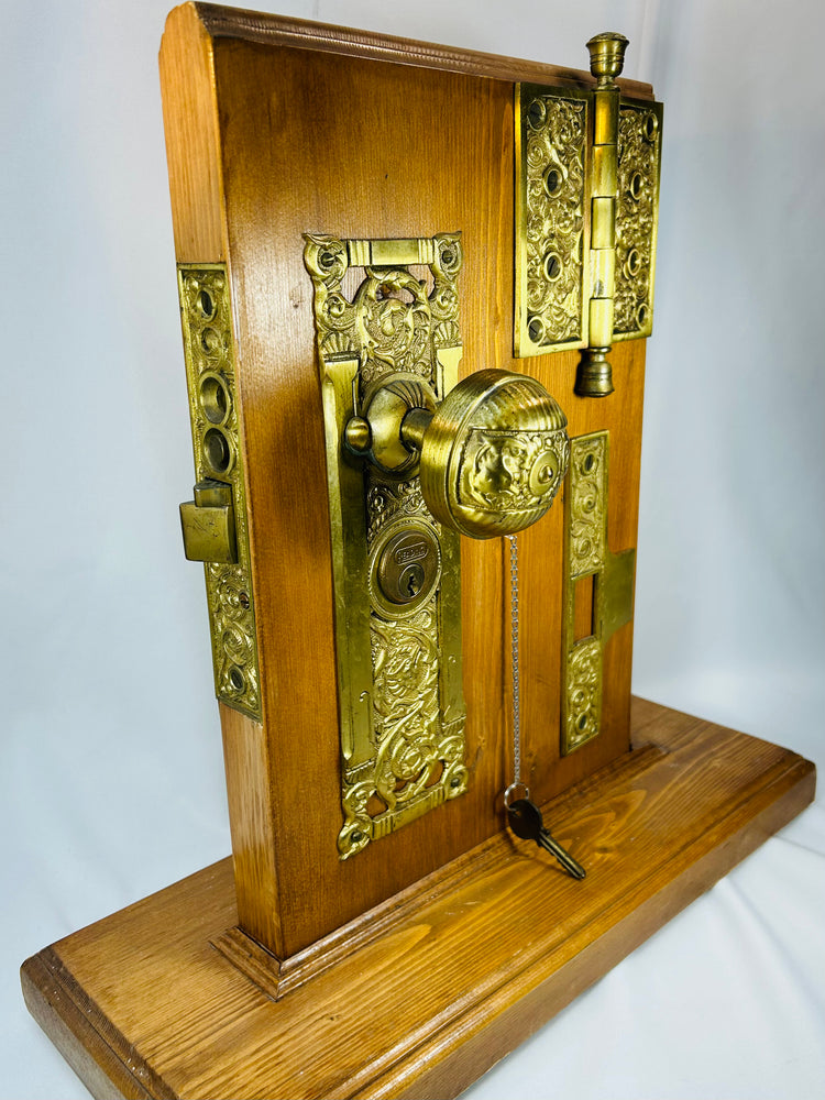 Vintage architectural hardware display with brass knob and strike plate