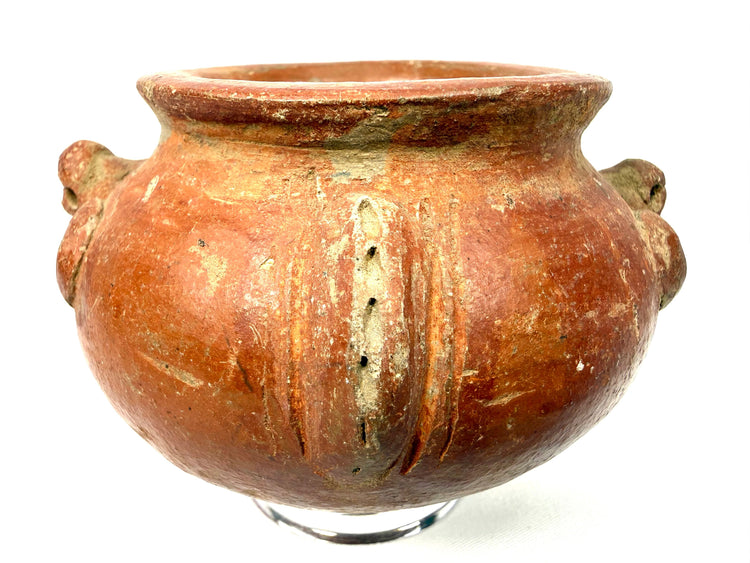 Ancient Pre-Columbian earthenware vessel displaying a broad flared rim, gently narrowing neck, and distinctive raised ornamental motifs.