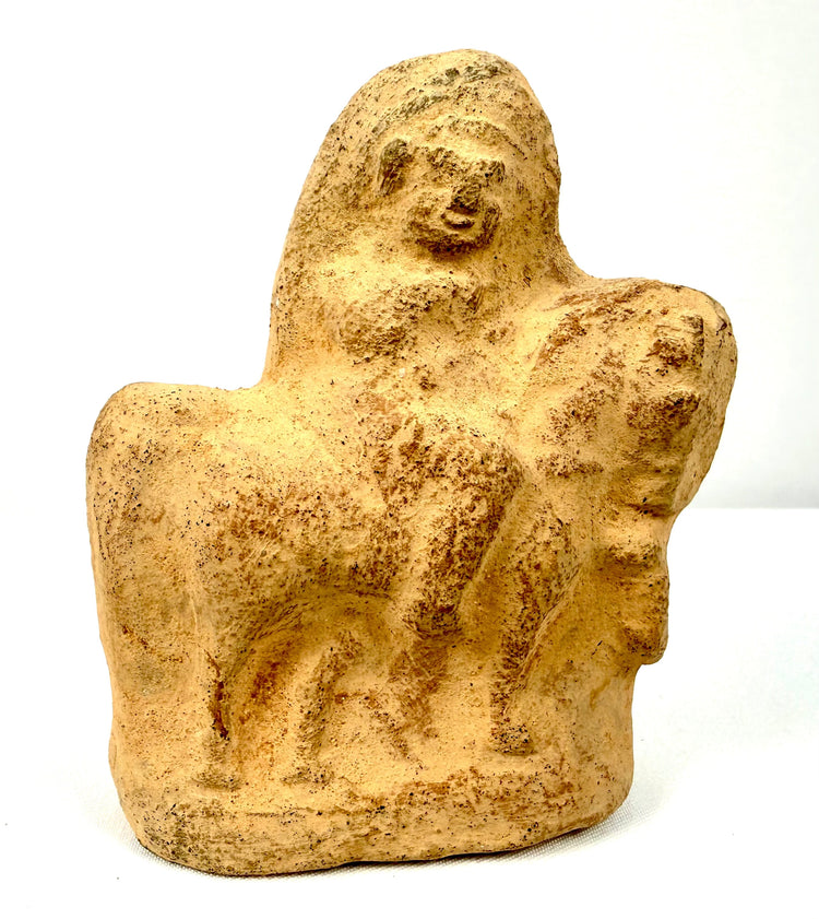 Roman Egyptian pottery figurine depicting a mounted horseman with stylized facial features, simplified anatomy, and earthy terracotta coloration.