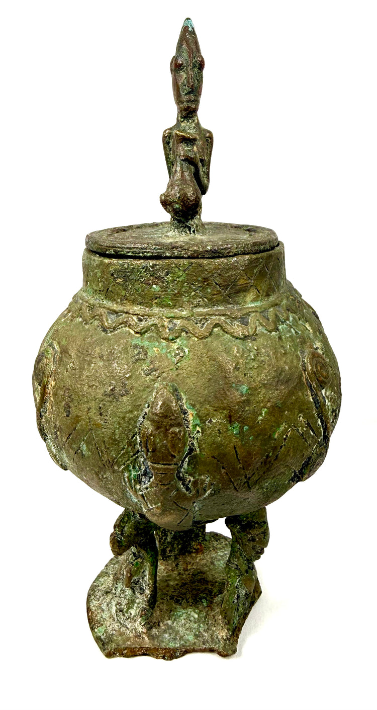 Dogon-attributed bronze vessel from Mali featuring a rounded body, figurative lid, and sculptural supports, circa 19th–early 20th century.