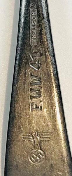Close-up of WWII German spoon handle with Rostfrei marking and Nazi eagle stamp dated 1941