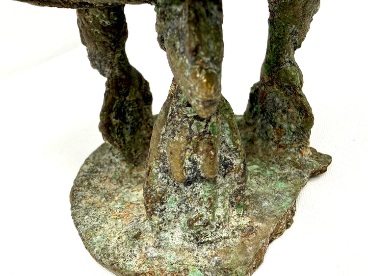 West African bronze artifact showcasing stylized anthropomorphic supports and traditional metalworking details.