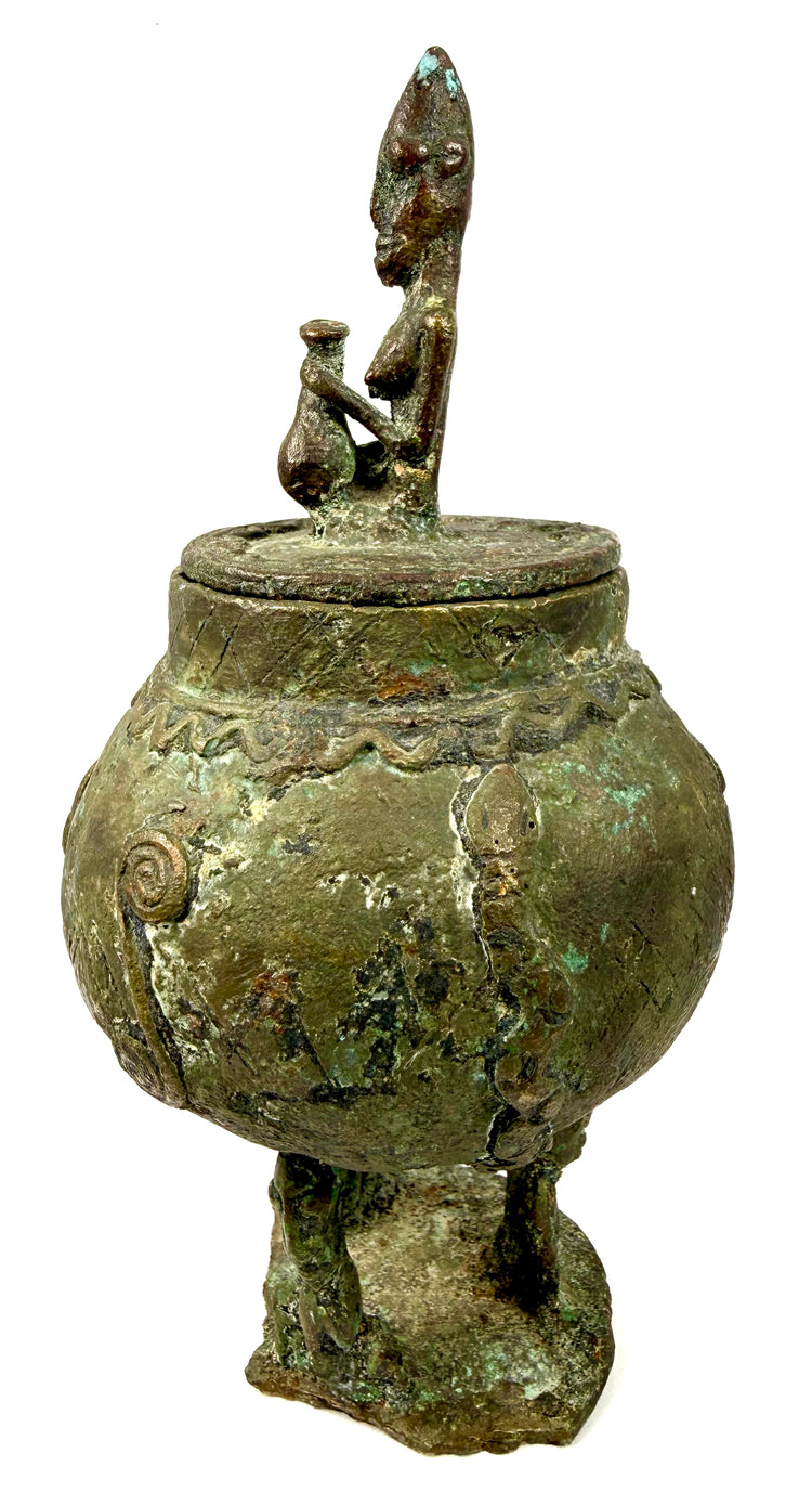 Traditional Malian bronze vessel featuring a bulbous body decorated with raised motifs and zigzag patterns.