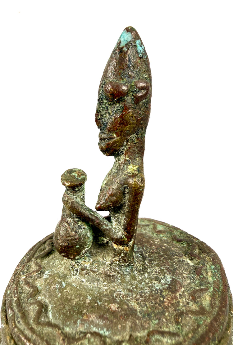 Antique African bronze vessel with extensive verdigris, weathered surfaces, and decorative geometric patterns.