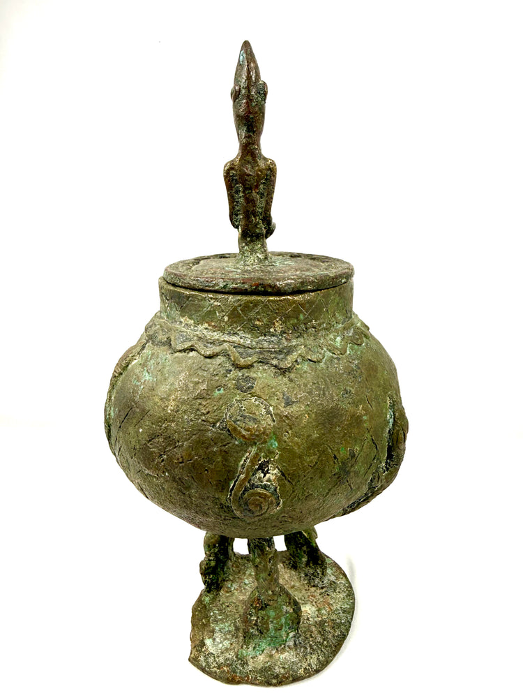 Antique Dogon bronze vessel displaying geometric ornamentation and rich green and brown patination.