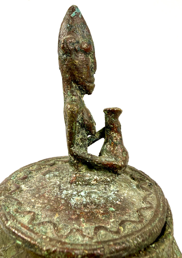 Historic Malian bronze vessel with a standing figurative lid ornament and naturally oxidized surface.