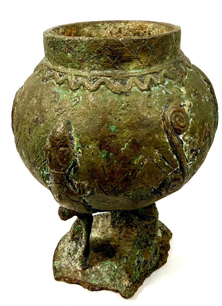 Dogon-attributed bronze artifact displaying intricate geometric bands along the upper section of its rounded body.