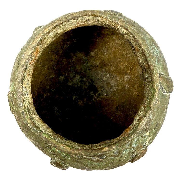 Traditional Dogon-style bronze vessel featuring figurative sculpture, raised decorative motifs, and irregular surface textures.
